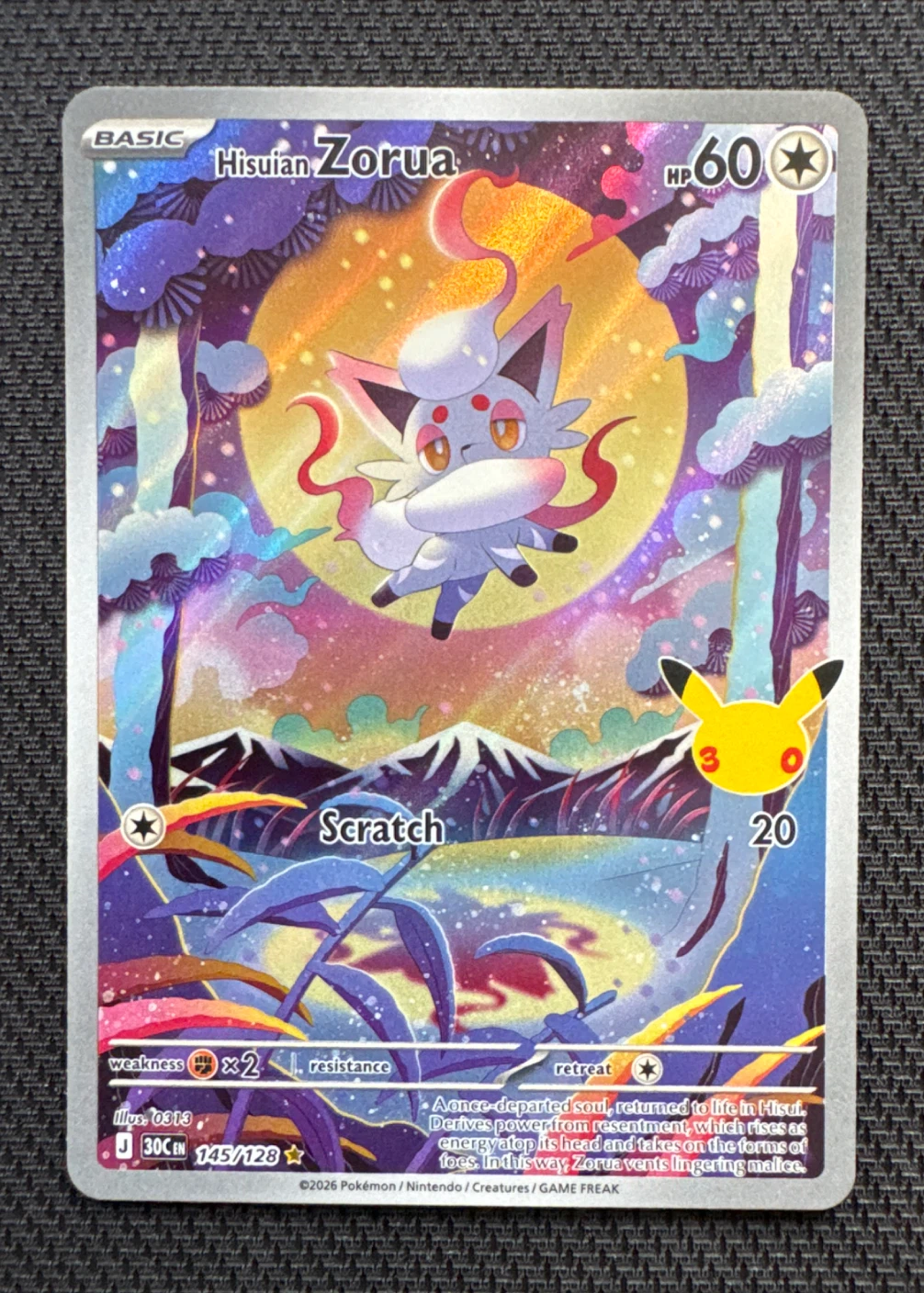 Hisuian Zorua 145/128 30th Celebration front card photo in PokeToGrade pregrading report